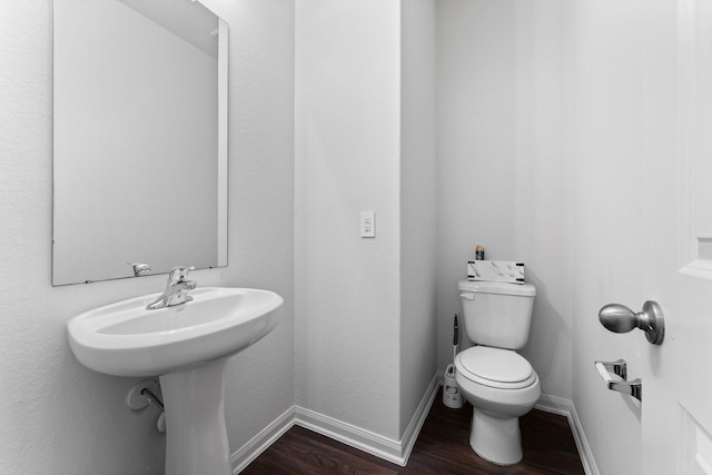 bathroom with wood-type flooring and toilet