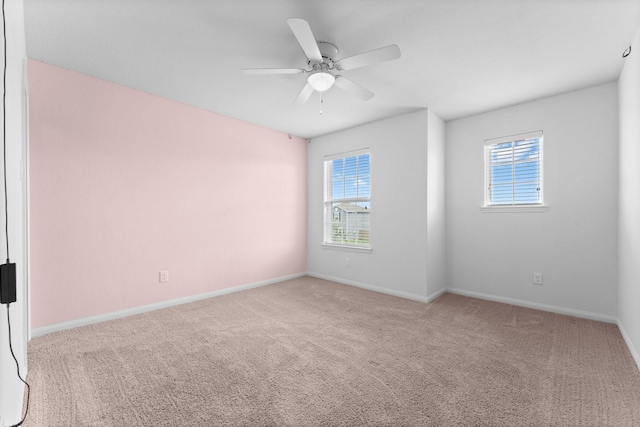 carpeted empty room featuring ceiling fan