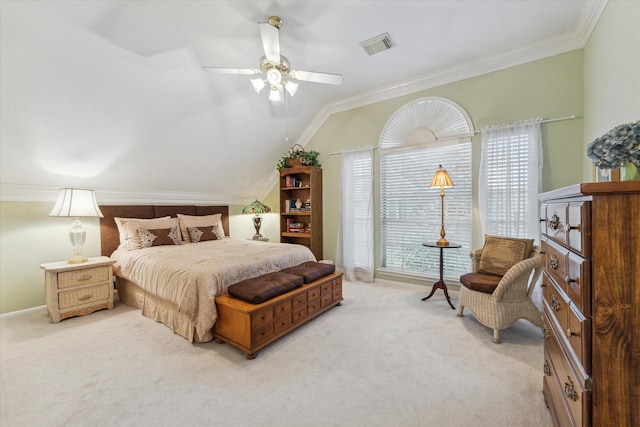 bedroom featuring ceiling fan, ornamental molding, light carpet, and vaulted ceiling