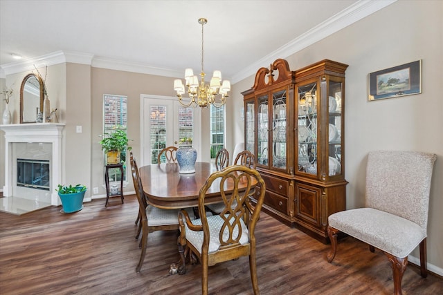 dining room with ornamental molding, a fireplace, dark wood-type flooring, and an inviting chandelier