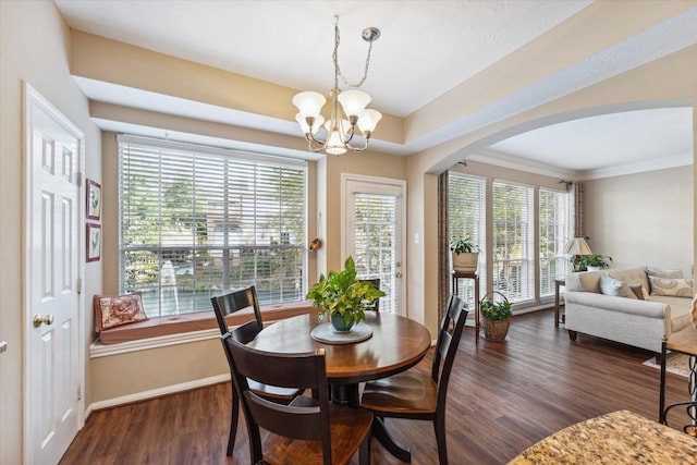 dining room with a chandelier, dark hardwood / wood-style floors, and crown molding