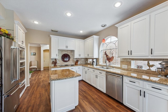 kitchen with white cabinets and appliances with stainless steel finishes