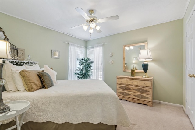 bedroom with ceiling fan and light colored carpet