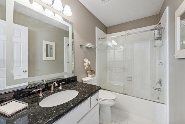 full bathroom featuring combined bath / shower with glass door, vanity, a textured ceiling, tile patterned flooring, and toilet