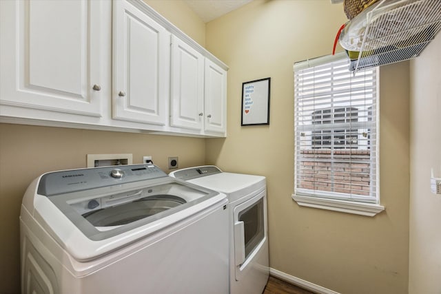 laundry room with washer and clothes dryer and cabinets