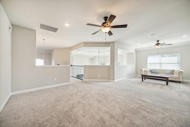 unfurnished living room featuring ceiling fan and carpet