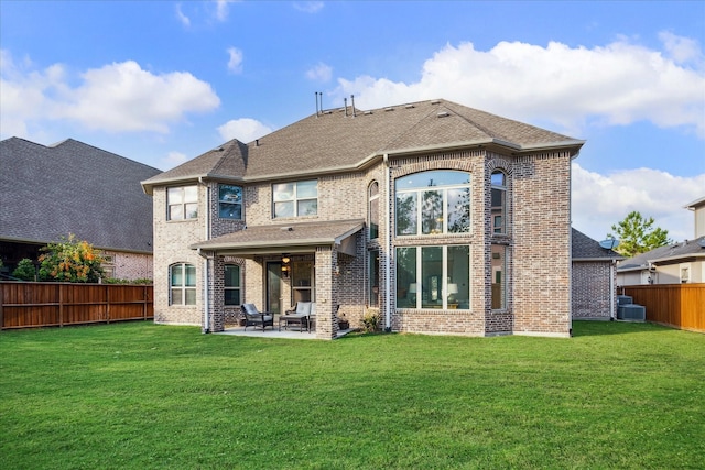 back of house featuring a lawn and a patio