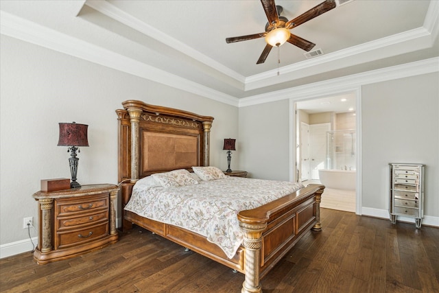 bedroom featuring a tray ceiling, ensuite bath, ceiling fan, and dark hardwood / wood-style floors