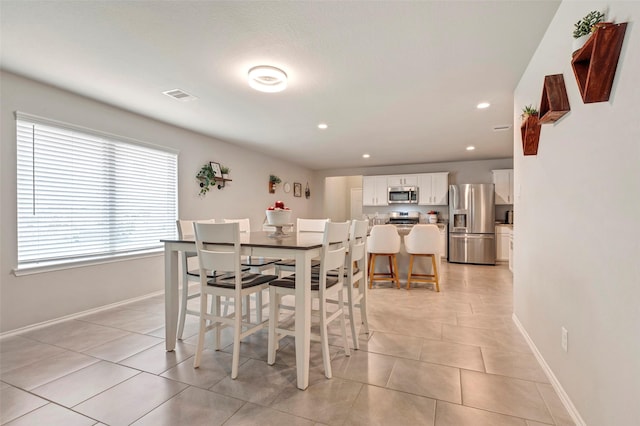 dining room featuring light tile patterned flooring