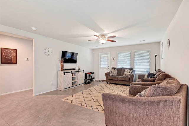 tiled living room with ceiling fan