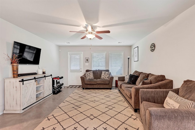 living room featuring ceiling fan and light tile patterned floors