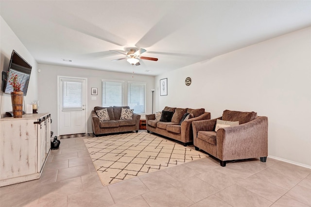 tiled living room featuring ceiling fan