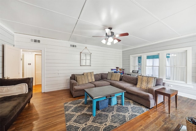 living room featuring hardwood / wood-style floors and wood walls