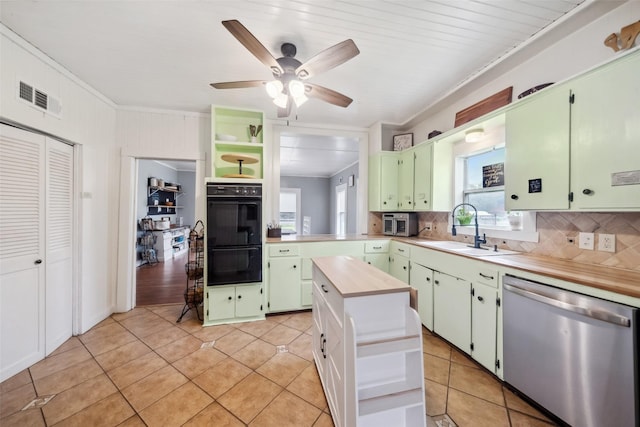 kitchen featuring backsplash, stainless steel dishwasher, black double oven, sink, and light tile patterned floors