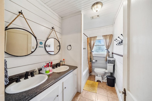 full bathroom featuring toilet, tile patterned floors, shower / bathtub combination, and wood walls