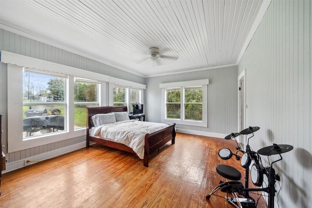 bedroom with ceiling fan, light wood-type flooring, and crown molding