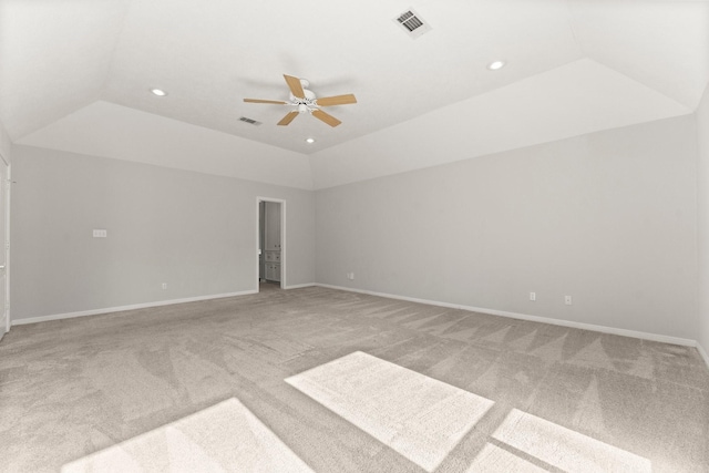 interior space with a tray ceiling, ceiling fan, and lofted ceiling