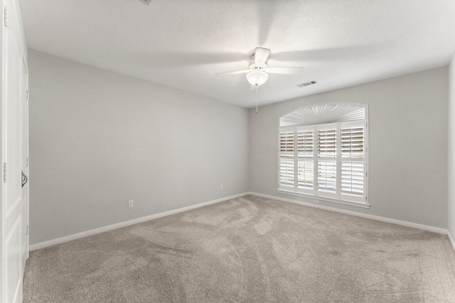 empty room featuring light colored carpet and ceiling fan