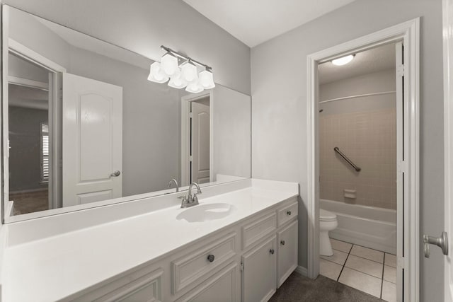 full bathroom with tile patterned floors, vanity, tiled shower / bath combo, and toilet