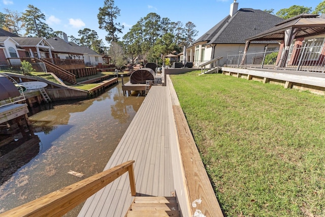 dock area featuring a gazebo, a yard, and a water view