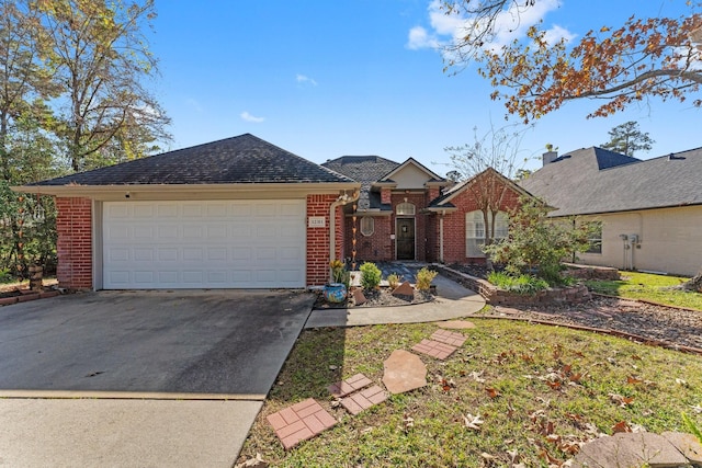 ranch-style home featuring driveway, roof with shingles, a garage, and brick siding