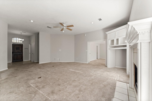 unfurnished living room with ceiling fan and light colored carpet