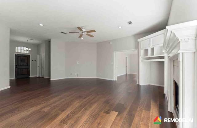 unfurnished living room with ceiling fan, a fireplace, visible vents, baseboards, and dark wood-style floors