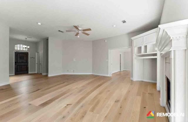 unfurnished living room featuring a ceiling fan, baseboards, visible vents, and light wood finished floors