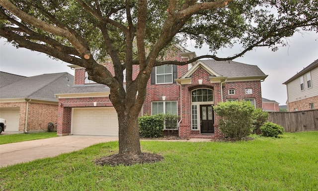 view of front of home with a front yard and a garage