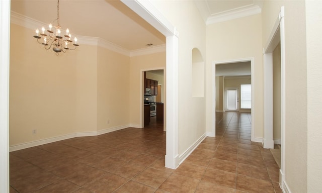 hallway with tile patterned flooring, crown molding, and an inviting chandelier