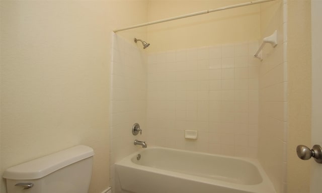 bathroom with washtub / shower combination and toilet