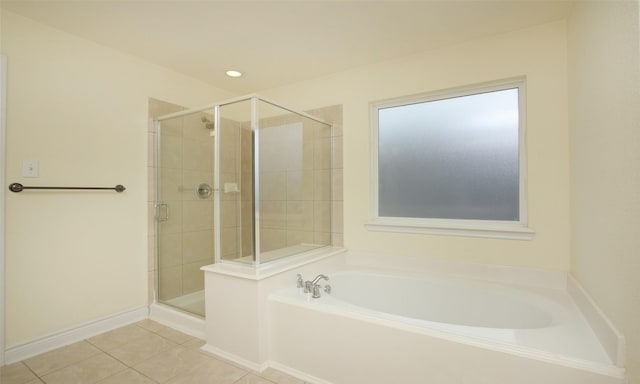 bathroom featuring tile patterned flooring and shower with separate bathtub