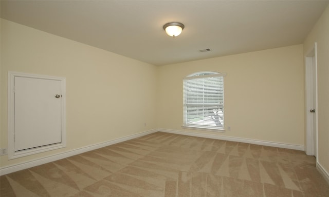 empty room featuring light colored carpet