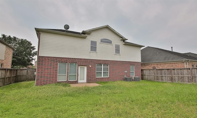 back of house with a lawn