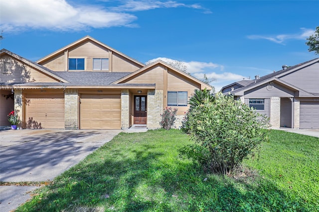 view of front of home featuring a front yard and a garage