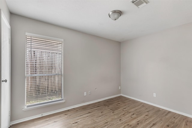 spare room with light hardwood / wood-style flooring