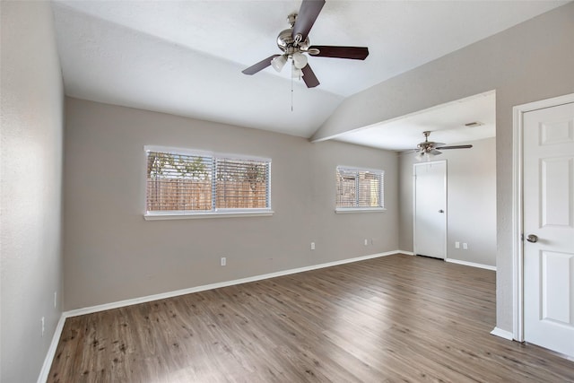 unfurnished room featuring wood-type flooring, vaulted ceiling, and ceiling fan