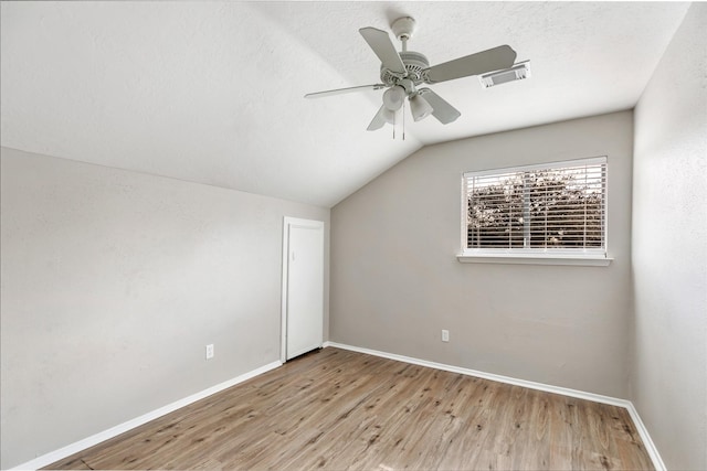 additional living space with ceiling fan, light hardwood / wood-style flooring, and vaulted ceiling