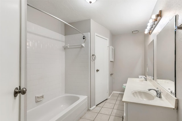 full bathroom featuring vanity, a textured ceiling, tile patterned floors, toilet, and tiled shower / bath