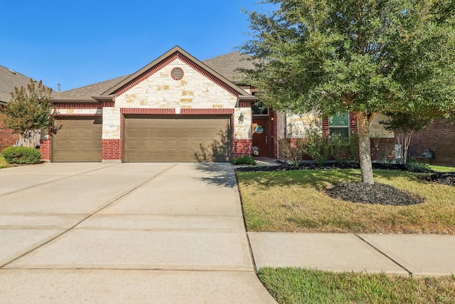 view of front of house featuring a garage and a front lawn