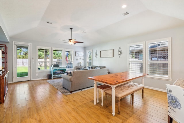 dining area featuring plenty of natural light, light hardwood / wood-style floors, and vaulted ceiling