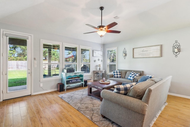 living room with ceiling fan and light hardwood / wood-style floors