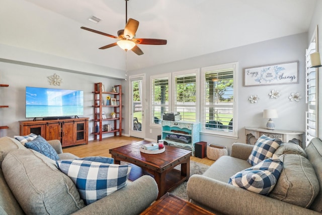 living room with ceiling fan and light wood-type flooring