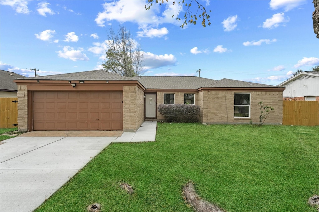 ranch-style home with a garage and a front lawn