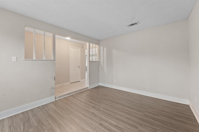 unfurnished room featuring light hardwood / wood-style floors