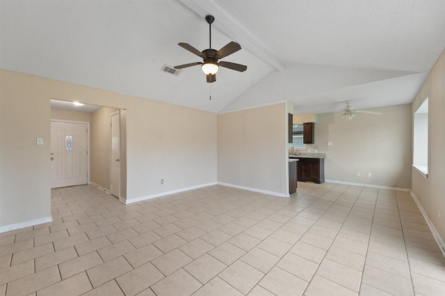 unfurnished room with light tile patterned floors, lofted ceiling with beams, a textured ceiling, and ceiling fan