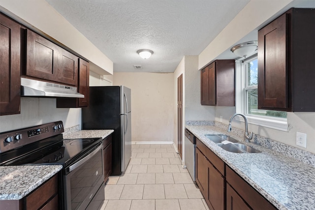 kitchen with light stone countertops, stainless steel appliances, extractor fan, and sink