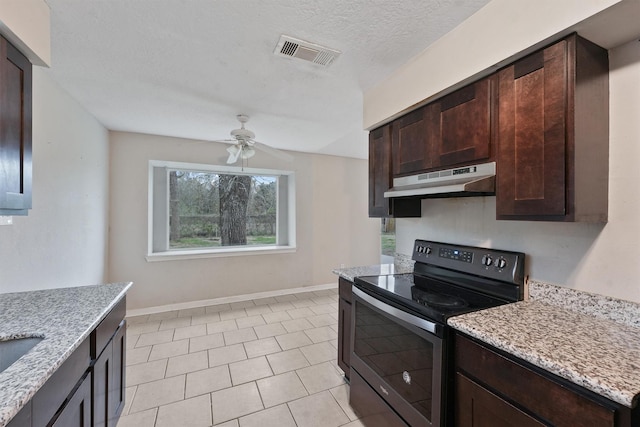 kitchen featuring a textured ceiling, light stone counters, stainless steel electric stove, and ceiling fan