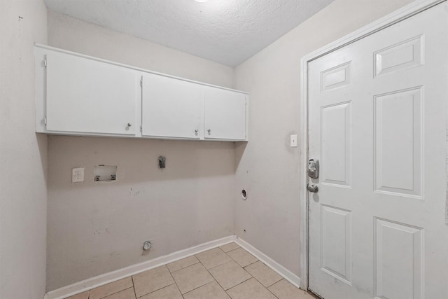 clothes washing area with washer hookup, electric dryer hookup, cabinets, and light tile patterned floors