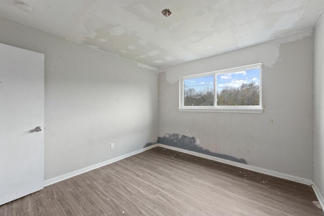 empty room with hardwood / wood-style floors